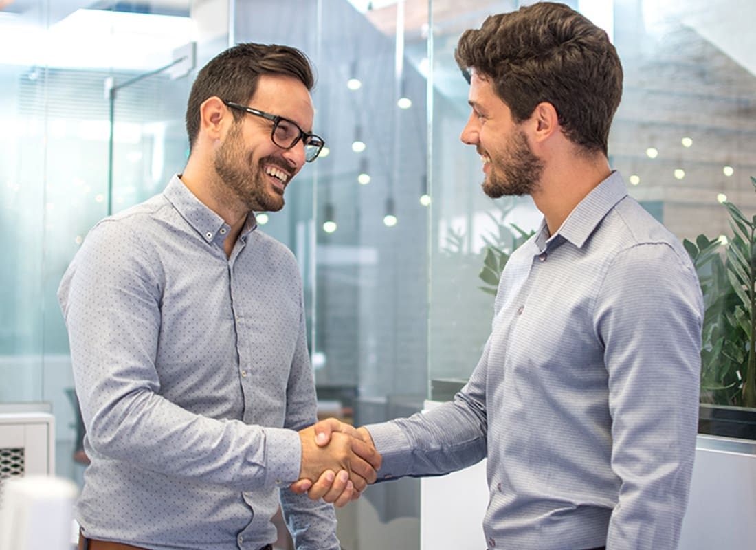 Insurance Solutions - Two Business People Shaking Hands